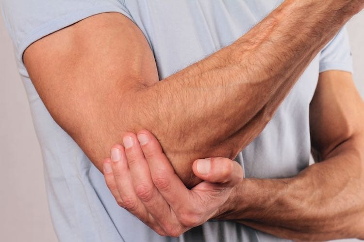 Man With Pain In Elbow. Pain relief concept