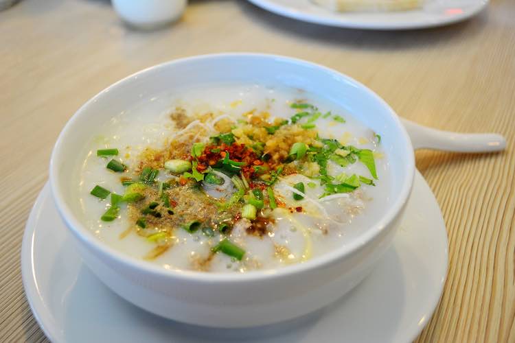 Rice porridge on the white bowl with spoon