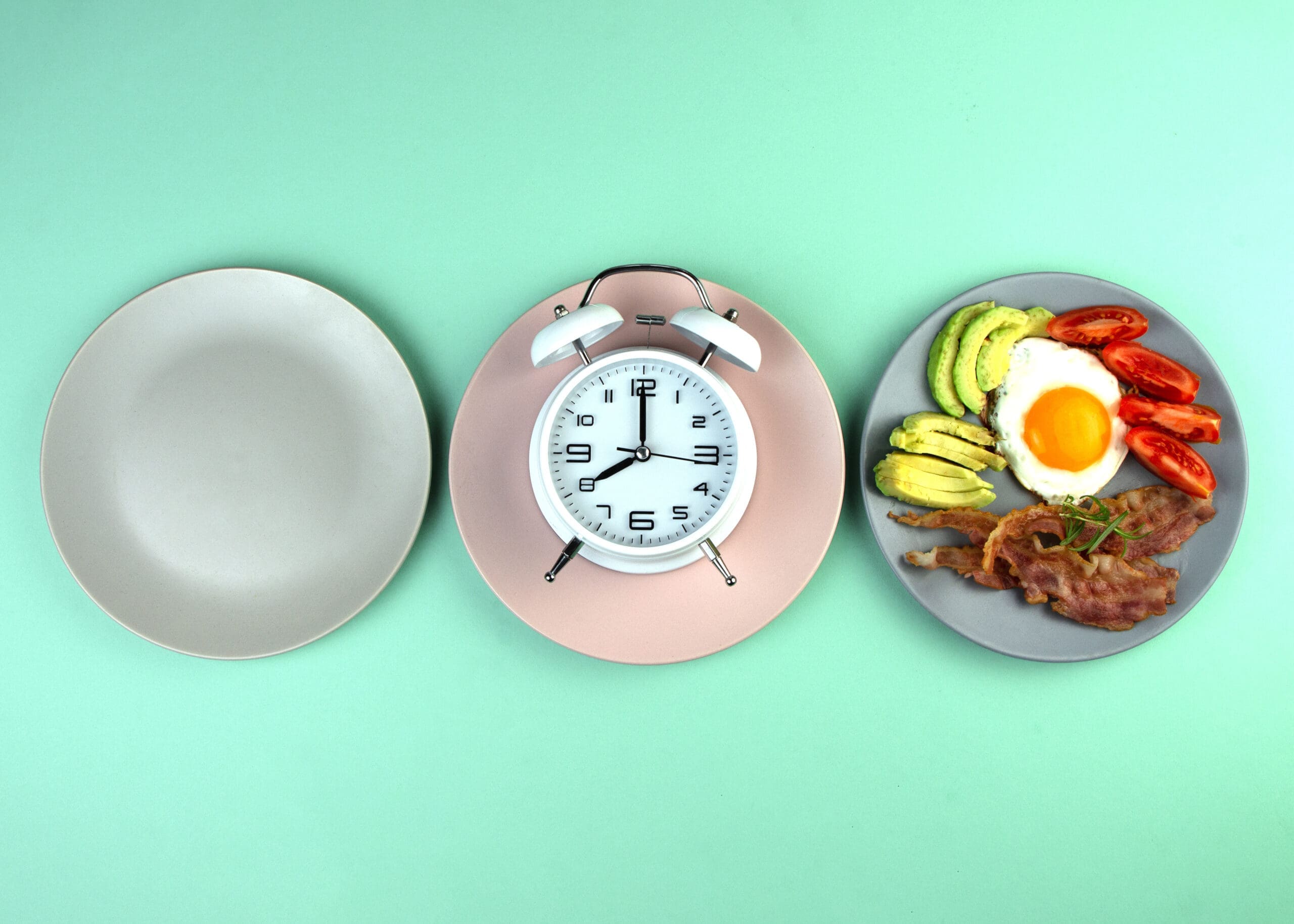 Intermittent fasting concept with empty colorful plates. Time to lose weight , eating control or time to diet concept. Intermittent Fasting diet